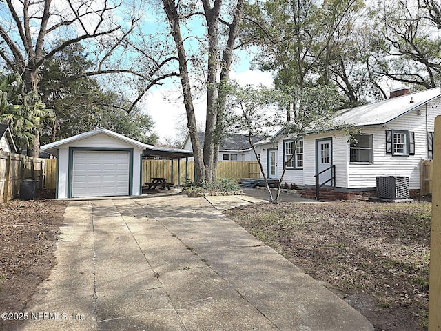 exterior space featuring central AC, a carport, a garage, and an outdoor structure