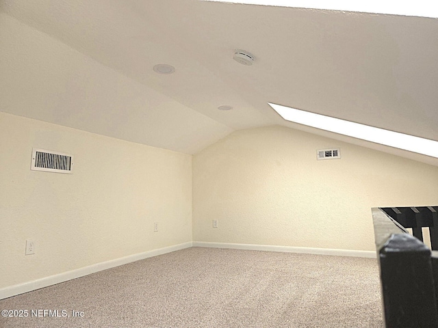 bonus room featuring lofted ceiling and carpet flooring