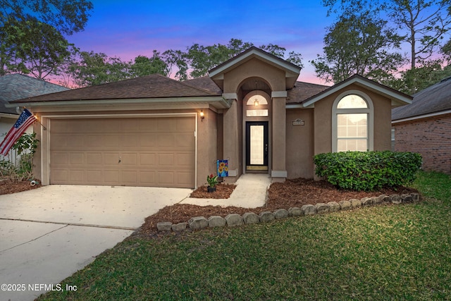 ranch-style house featuring stucco siding, a garage, concrete driveway, and a shingled roof