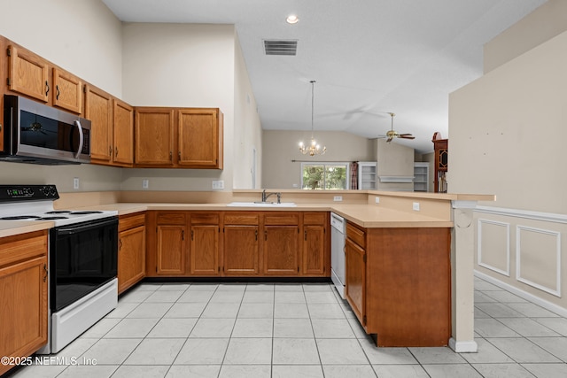 kitchen with visible vents, range with electric cooktop, stainless steel microwave, a peninsula, and dishwasher