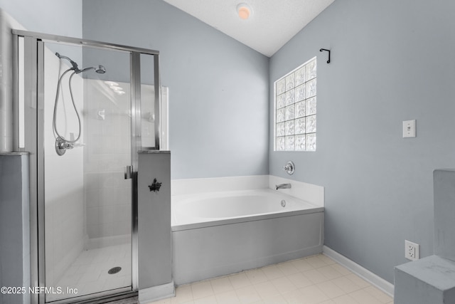 bathroom with a shower stall, a bath, baseboards, and vaulted ceiling