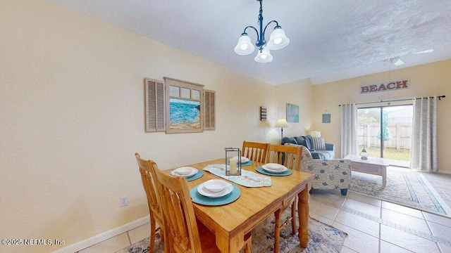 dining room with baseboards, a chandelier, a textured ceiling, and light tile patterned flooring