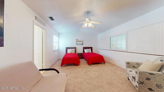 bedroom featuring lofted ceiling, light carpet, ceiling fan, and visible vents