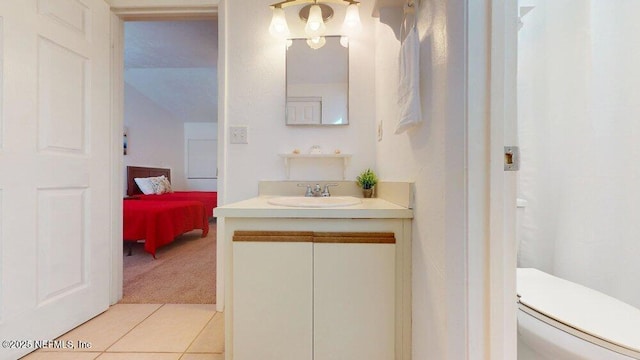 ensuite bathroom with tile patterned floors, vanity, toilet, and ensuite bathroom