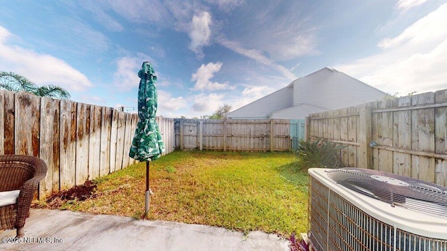 view of yard with a fenced backyard and cooling unit