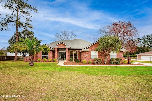 view of front of home with a front lawn, a shingled roof, fence, and brick siding