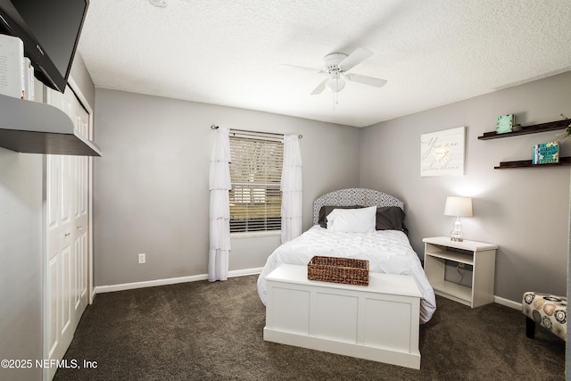 carpeted bedroom featuring ceiling fan and a textured ceiling