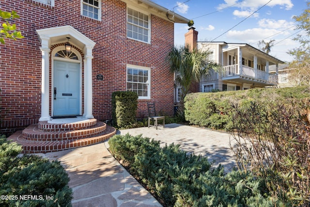 property entrance featuring a patio area