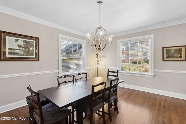 dining area with dark hardwood / wood-style flooring, plenty of natural light, and ornamental molding