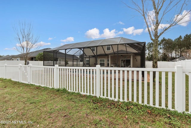 view of property exterior featuring a lanai and a lawn