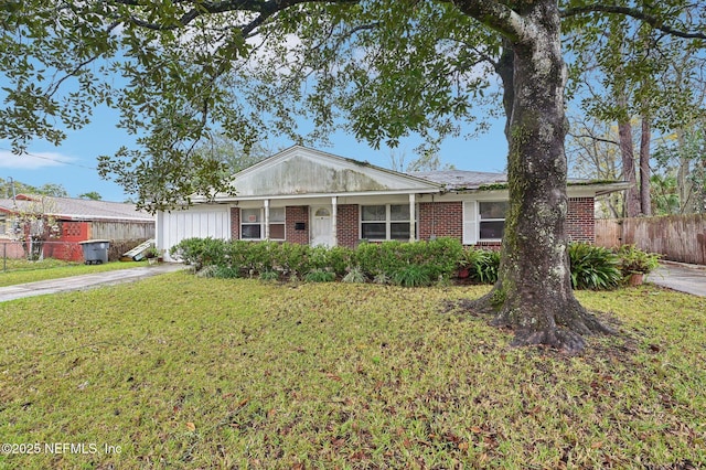 single story home with driveway, brick siding, a front lawn, and fence