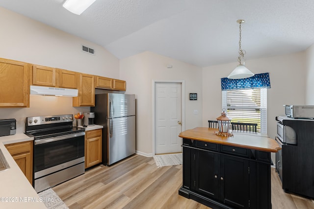 kitchen featuring appliances with stainless steel finishes, lofted ceiling, light wood-type flooring, pendant lighting, and a textured ceiling