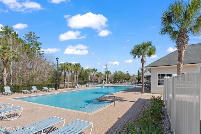 pool featuring fence and a patio