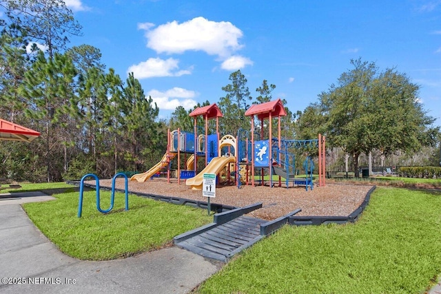 community jungle gym featuring a yard