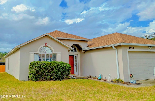 view of front of house with a garage, a shingled roof, a front yard, and stucco siding