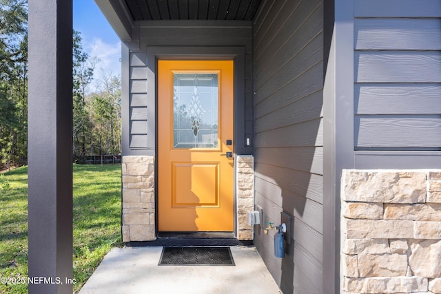 doorway to property featuring stone siding