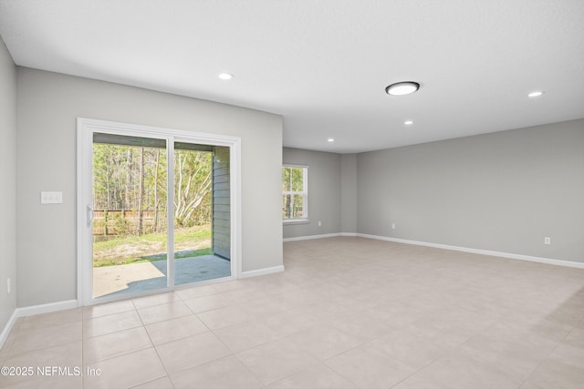 unfurnished room with recessed lighting and baseboards