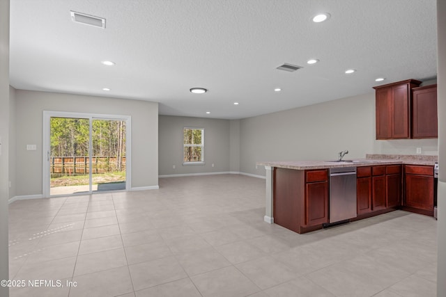 kitchen with open floor plan, visible vents, a peninsula, and stainless steel dishwasher