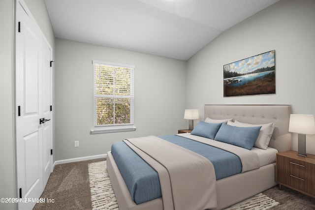 bedroom with carpet flooring, vaulted ceiling, and baseboards