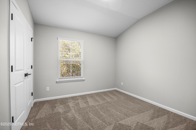 unfurnished bedroom featuring carpet flooring and baseboards