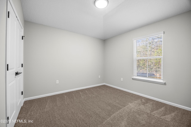 unfurnished bedroom featuring carpet and baseboards