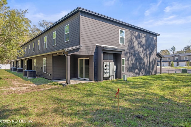 rear view of property featuring a patio area and a yard