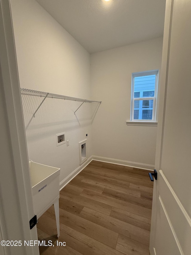 washroom featuring hookup for a washing machine, wood-type flooring, and electric dryer hookup