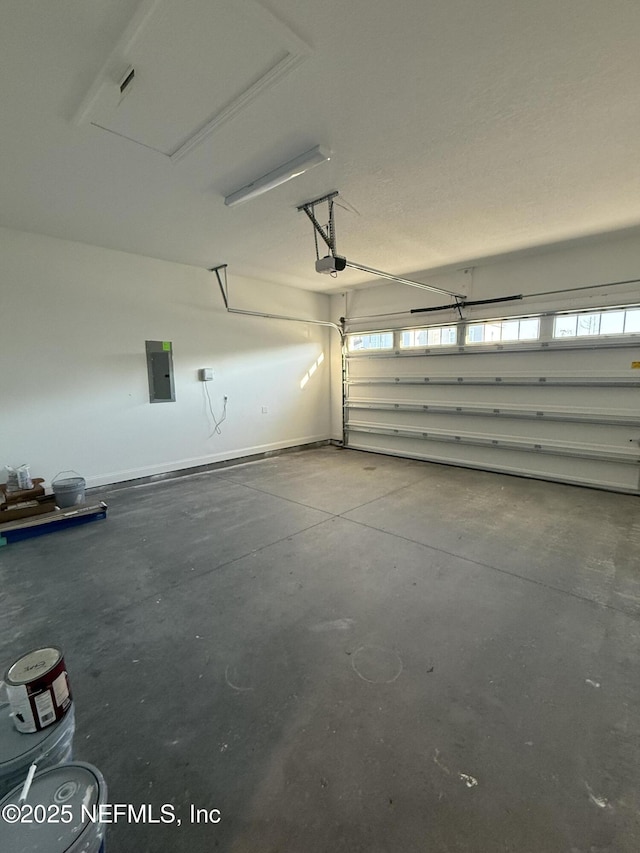 garage featuring a garage door opener and electric panel