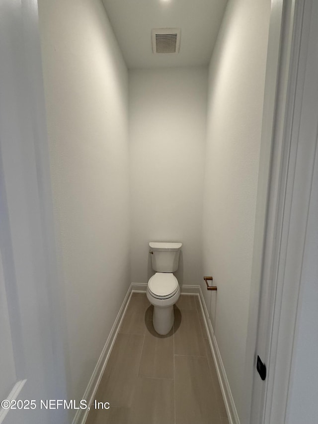 bathroom featuring tile patterned floors and toilet