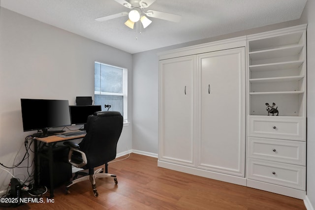 office with ceiling fan, light hardwood / wood-style flooring, and a textured ceiling