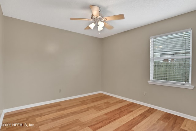 spare room featuring ceiling fan, a textured ceiling, and light wood-type flooring