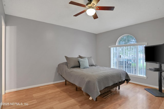 bedroom with ceiling fan and light hardwood / wood-style floors