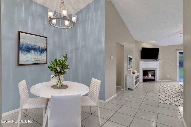 dining room with an inviting chandelier, lofted ceiling, and light tile patterned floors