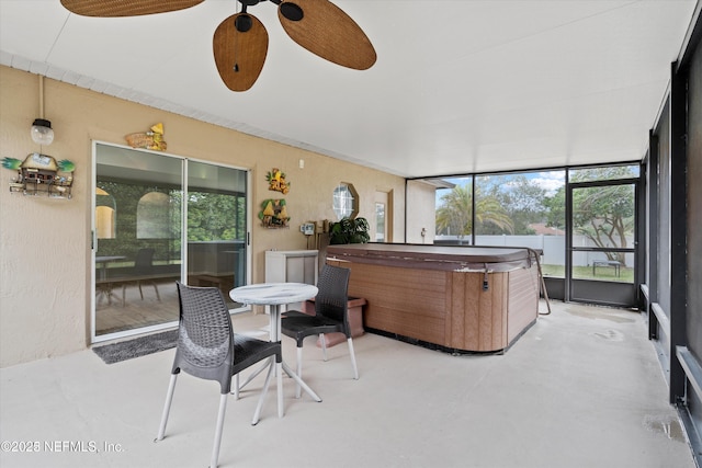 sunroom featuring plenty of natural light and a ceiling fan