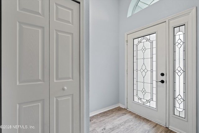 entrance foyer featuring light wood finished floors and baseboards