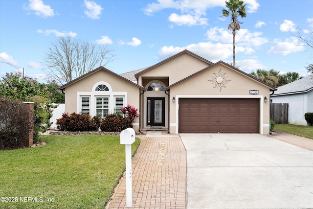 ranch-style house with stucco siding, an attached garage, concrete driveway, and a front yard