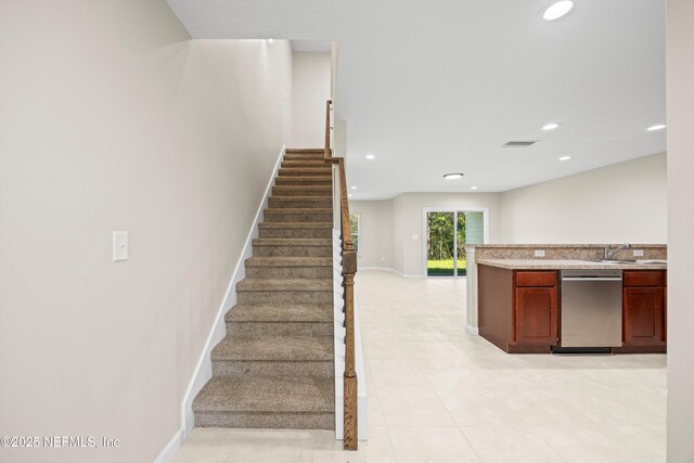 stairs featuring tile patterned floors, baseboards, visible vents, and recessed lighting