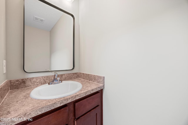 bathroom with visible vents and vanity