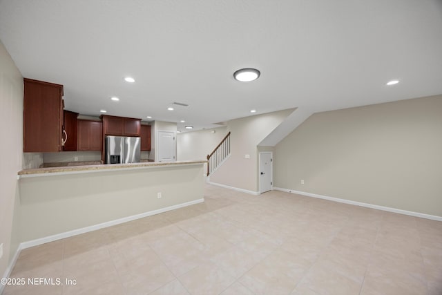 kitchen with recessed lighting, baseboards, light countertops, and stainless steel fridge with ice dispenser