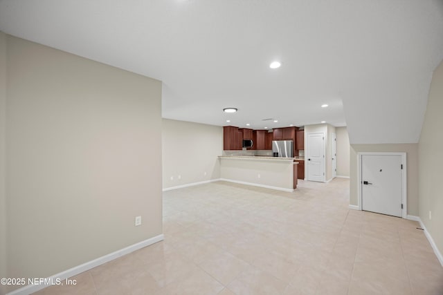 unfurnished living room featuring recessed lighting and baseboards