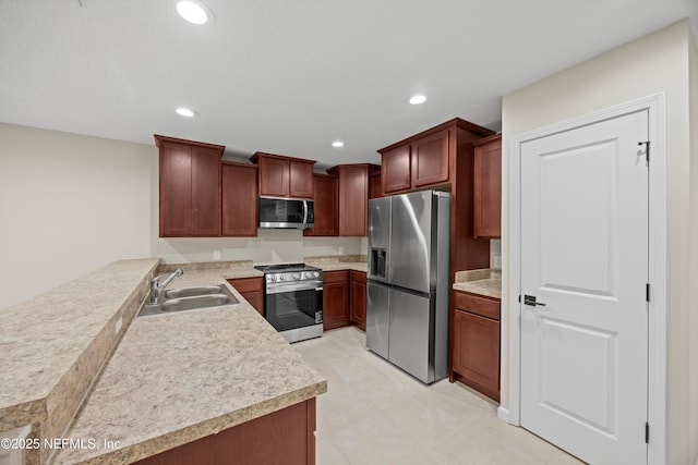 kitchen with recessed lighting, stainless steel appliances, a sink, and light countertops