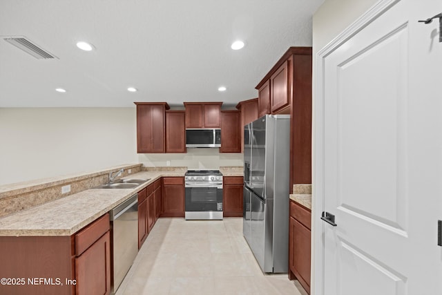 kitchen with recessed lighting, stainless steel appliances, a sink, visible vents, and light countertops