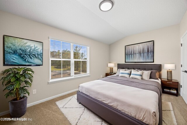 carpeted bedroom featuring vaulted ceiling, a textured ceiling, and baseboards