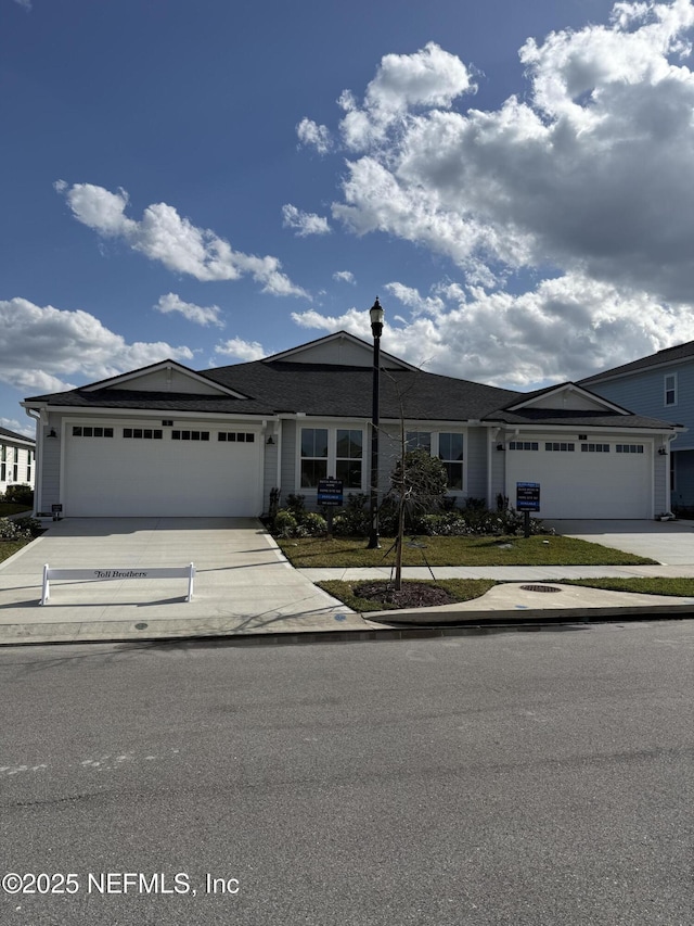 view of front of home with concrete driveway and a garage