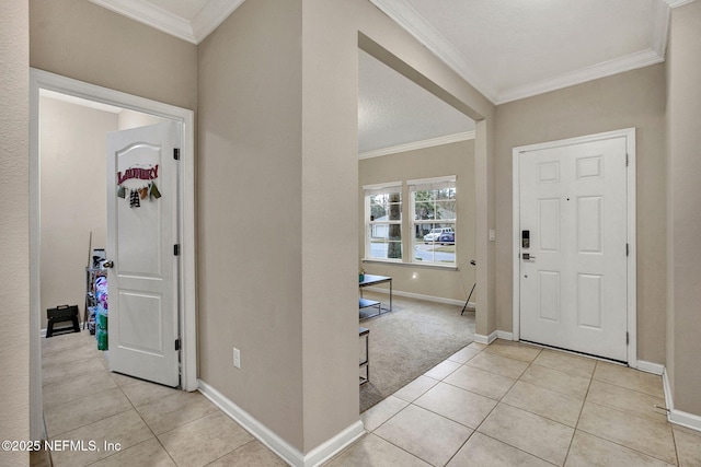 tiled entrance foyer featuring ornamental molding