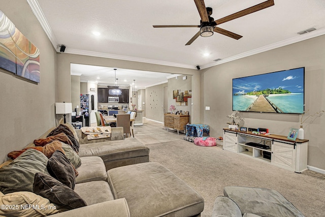 living room featuring ornamental molding, light carpet, and ceiling fan