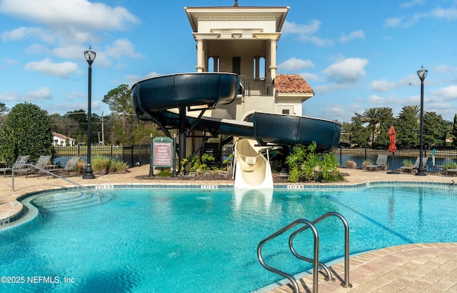 view of swimming pool featuring a patio and a water slide
