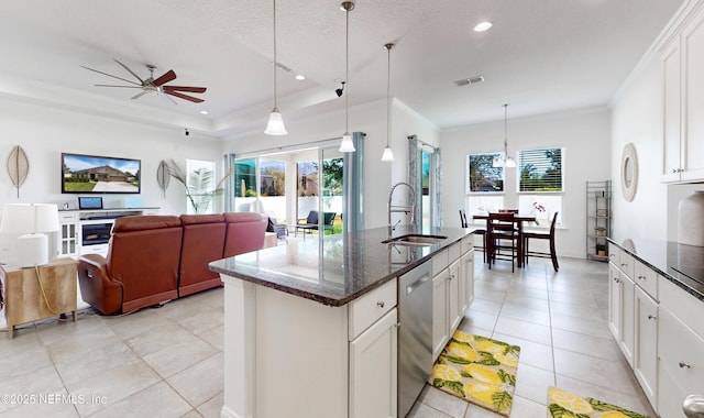 kitchen featuring white cabinets, an island with sink, sink, and stainless steel dishwasher