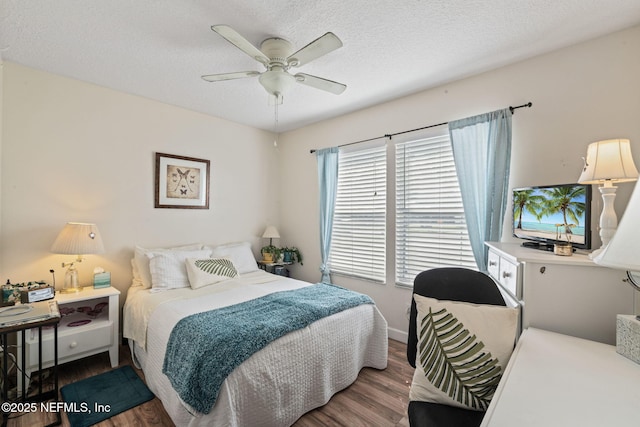 bedroom featuring hardwood / wood-style floors, ceiling fan, and a textured ceiling