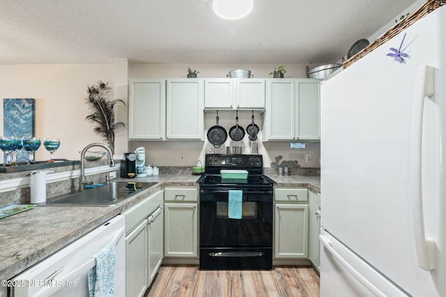 kitchen featuring light wood-type flooring, sink, white appliances, a textured ceiling, and white cabinets